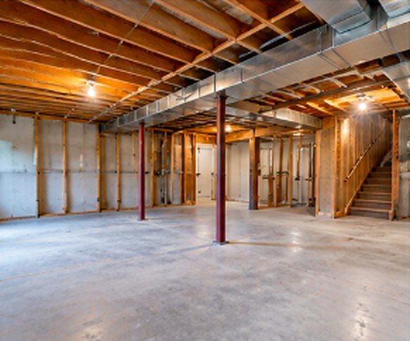 Unfinished basement with exposed framing and joists