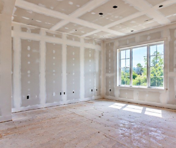 Bedroom with hung and taped drywall before finishing