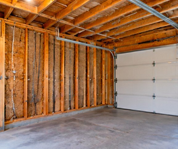Garage before drywall with open wood framing and insulation